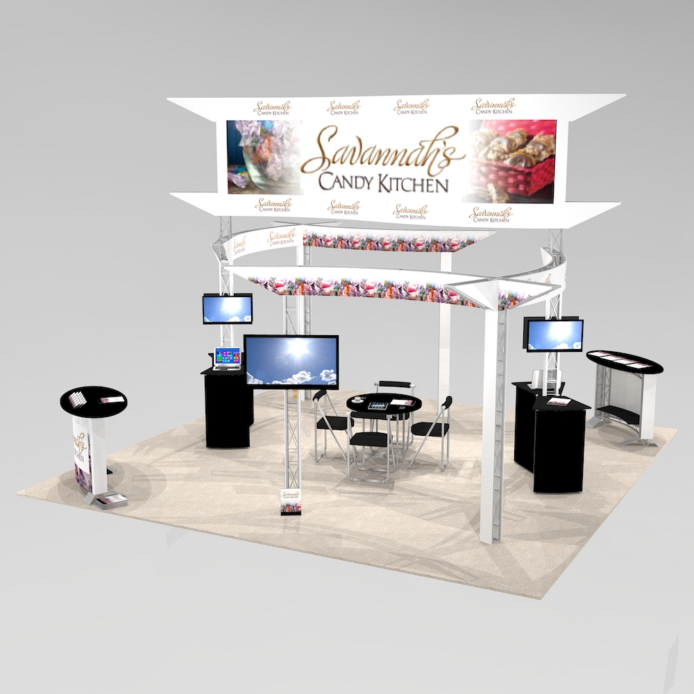 The PAL2020 is an island exhibit design featuring multiple curving panels just above eye level. A massive, raised logo sign ensures visibility throughout the trade show floor. Well-spaced towers with monitor screens and up to 7 workstations. View 1